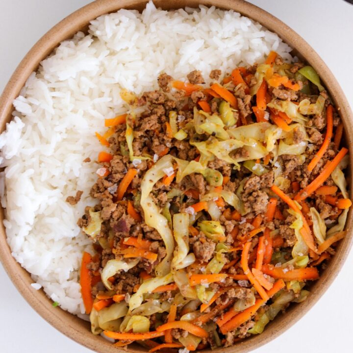 ground beef and cabbage with carrots in a bowl with rice