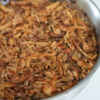 crispy chicken carnitas in a pan after broiling in an oven