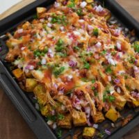 air fried butternut squash topped with cheese, rotisserie chicken, red onion and jalapeno, and bbq sauce