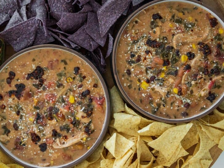 two bowls of creamy chicken taco soup with tortilla chips
