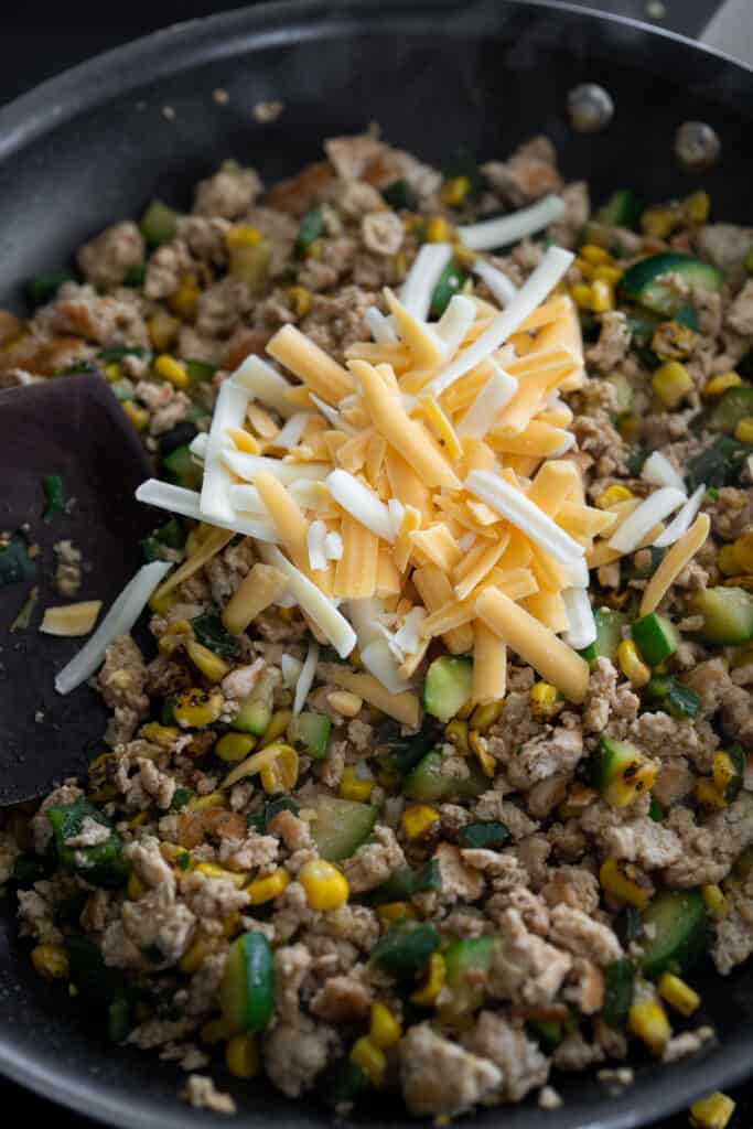 shredded Mexican cheese added to the cooked ground turkey and veggies