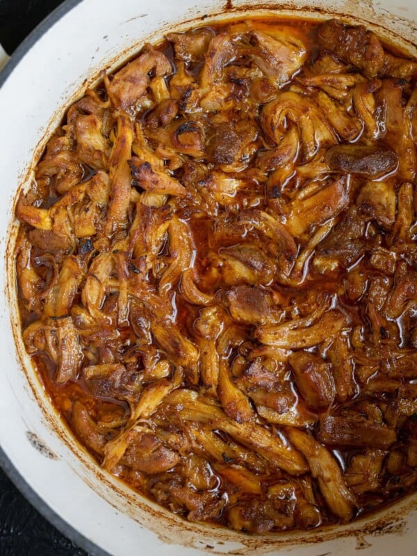 shredded BBQ chicken in a white Dutch oven