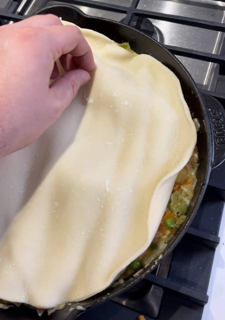 making a rotisserie chicken pot pie in a cast iron skillet