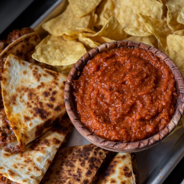 smoked salsa in a bowl on a sheet pan with beef quesadillas and tortilla chips