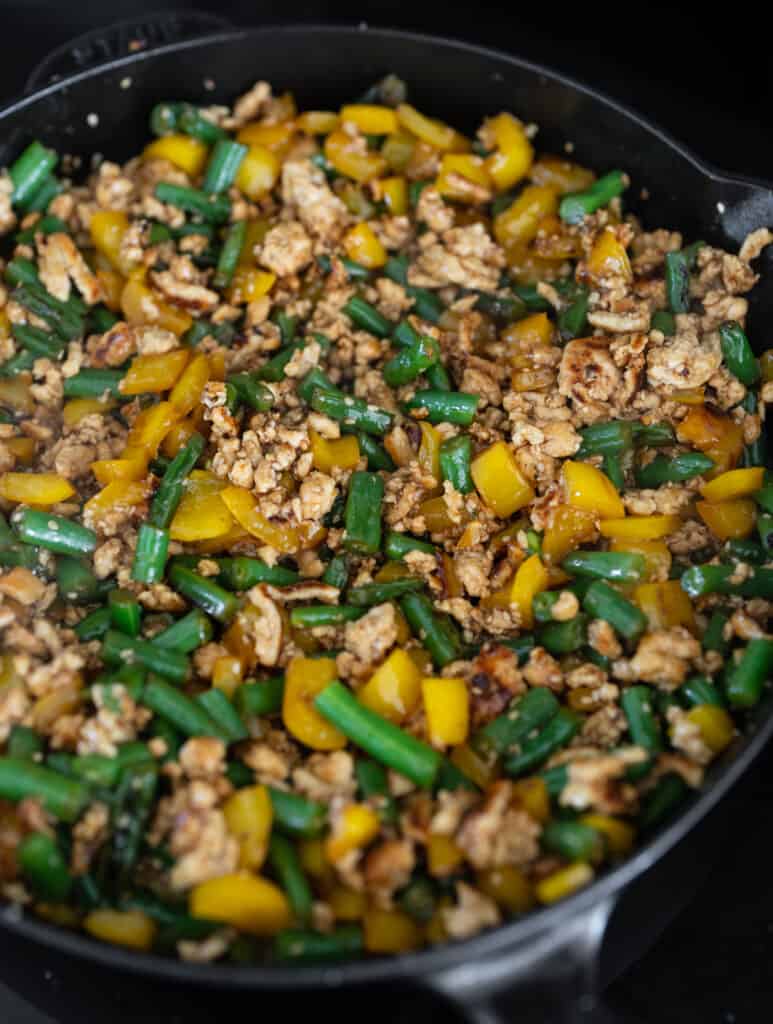 cooked honey sesame ground chicken with bell pepper and green beans