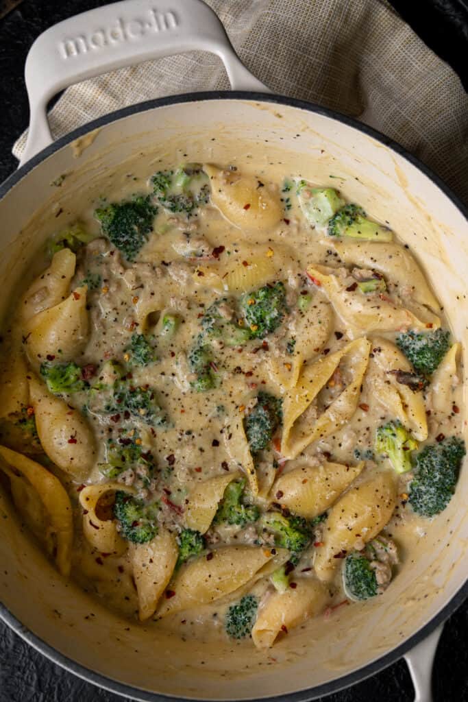 Dutch oven filled with lemon ricotta pasta with ground turkey and roasted broccoli
