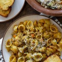 pumpkin bolognese with pasta shells served with garlic bread and a caesar salad
