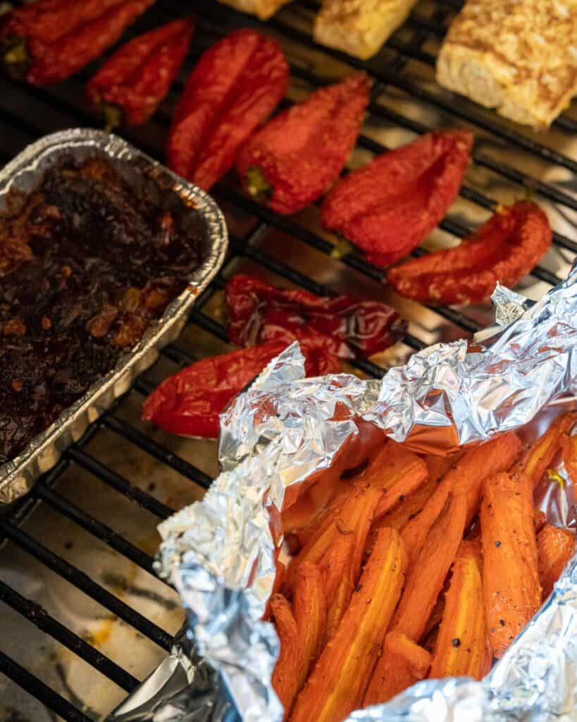 smoked carrots, pineapple, peppers, chipotle peppers, and raisins on a Traeger grill