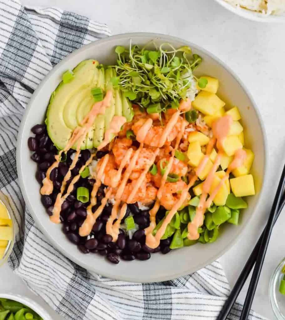 chili lime shrimp with black beans, mango, snap peas, green onion, avocado, rice, and spicy mayo