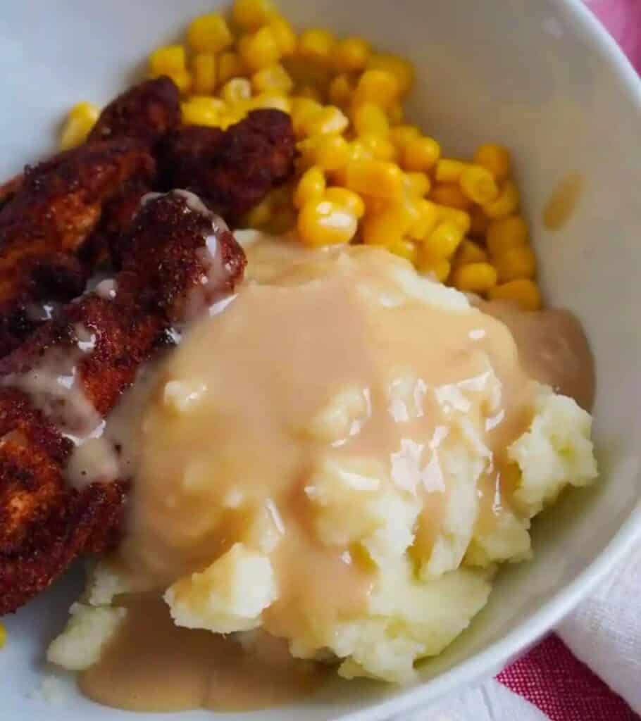 blackened chicken bowls with corn and mashed potatoes and gravy