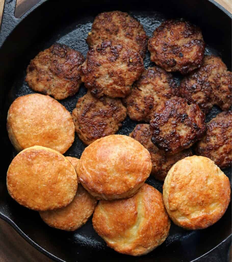 chicken sausage patties in a skillet with biscuits