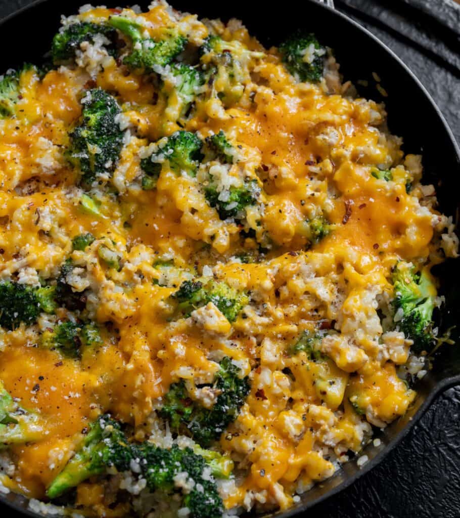 cast iron skillet with cheesy ground chicken and broccoli with rice