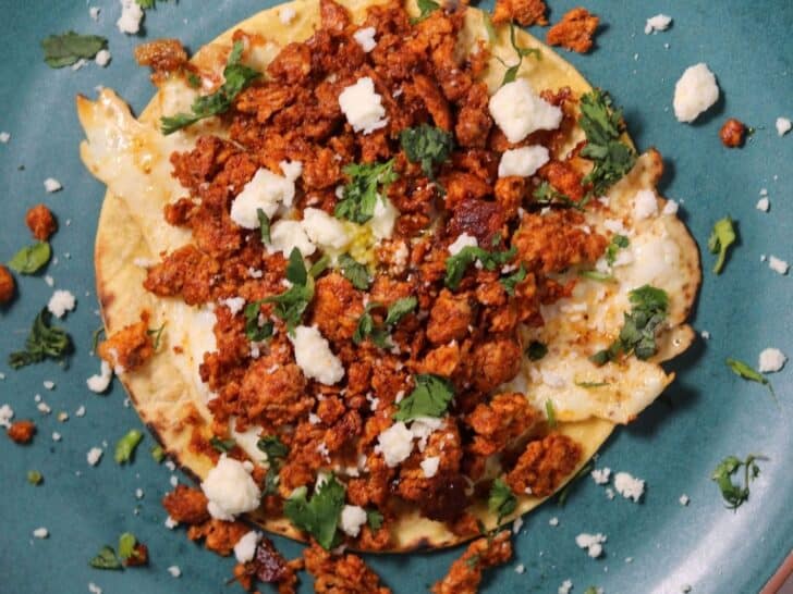 chorizo breakfast taco on a green plate