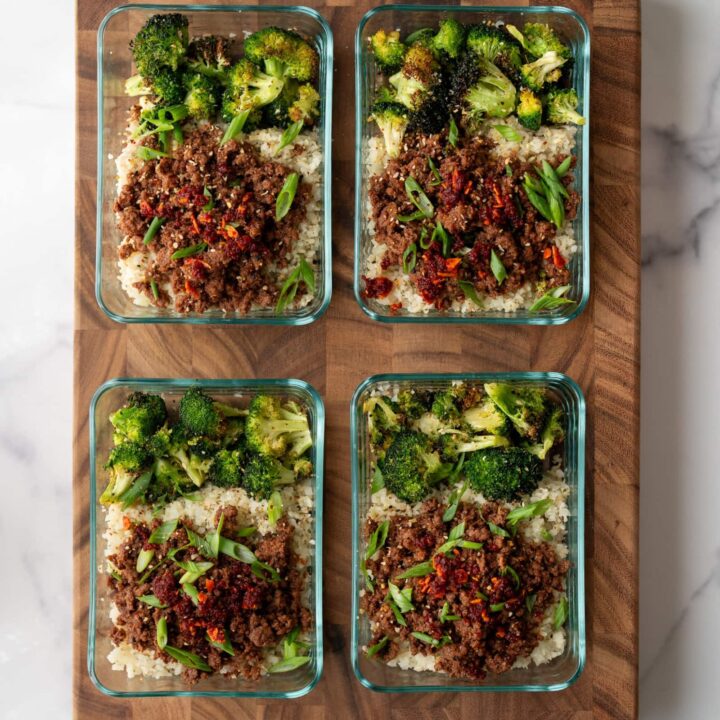 four ground bison protein bowls in glass meal prep containers