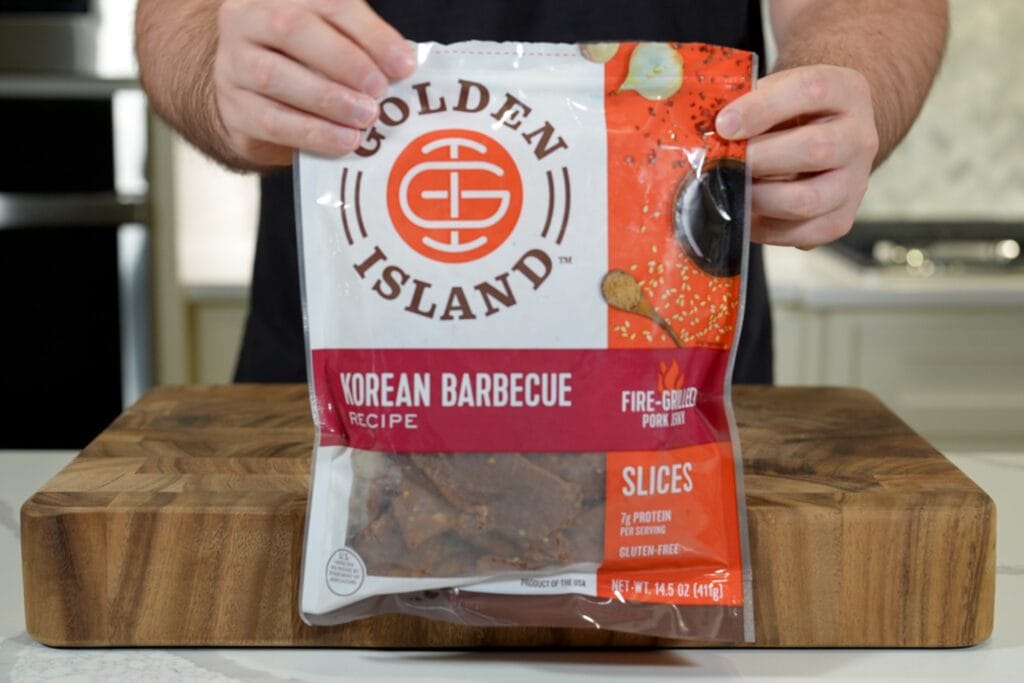 holding a package of Golden Island Korean barbecue pork jerky
