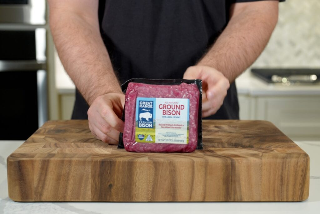 holding a package of Great Range ground bison from Costco