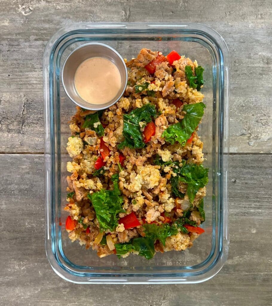 glass meal prep container with ground turkey and kale