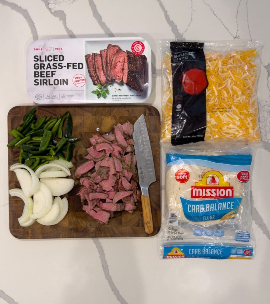 cuisine solutions sliced sirloin with sliced onions and peppers, Mexican cheese, and Mission carb balance tortillas