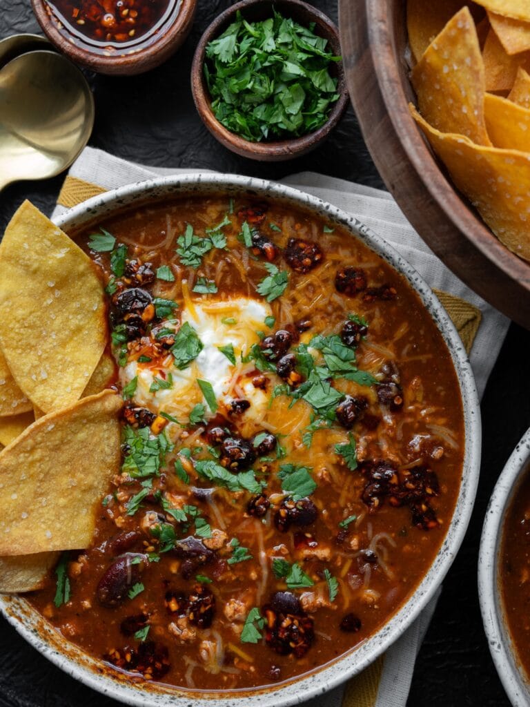 bowl of turkey chili with baked tortilla chips