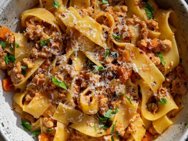 bowl of pappardelle pasta with ground turkey bolognese and parmigiano reggiano