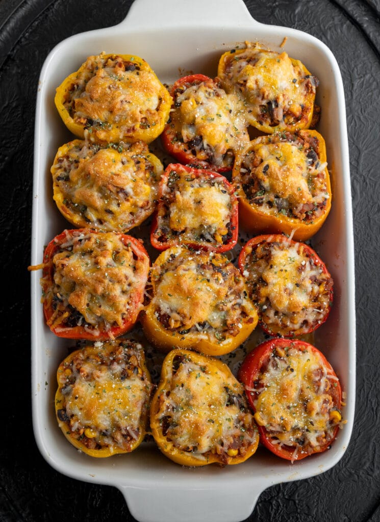 Mexican stuffed peppers with ground chicken in a baking dish