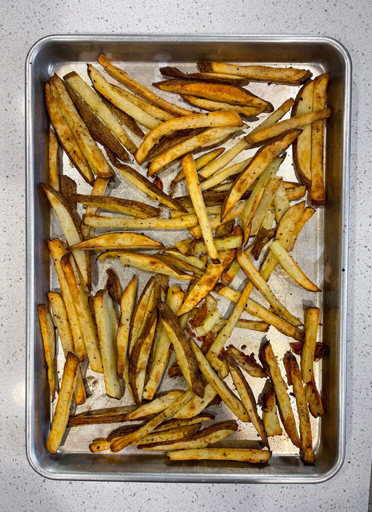 baked french fries on a half sheet pan