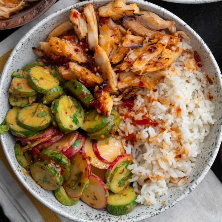 sweet chili rotisserie chicken in a bowl with half calorie rice and cucumber crunch salad