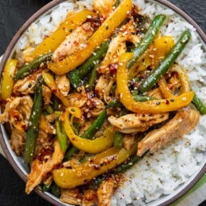 honey sesame rotisserie chicken and veggies over rice with toasted sesame seeds