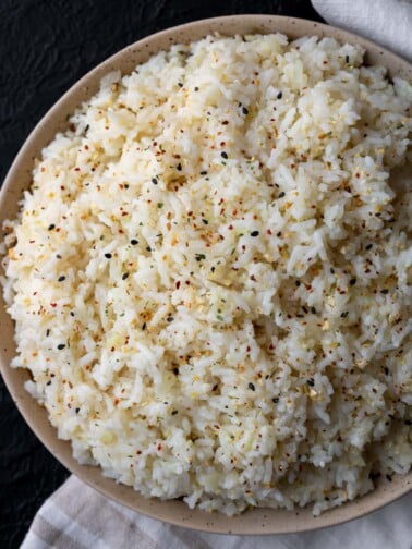 half calorie rice in a bowl garnished with sesame garlic crunch