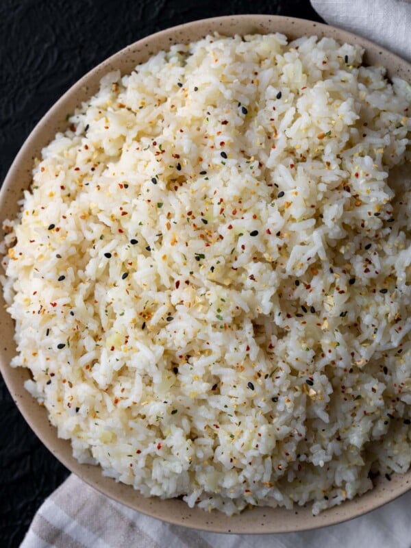 half calorie rice in a bowl garnished with sesame garlic crunch
