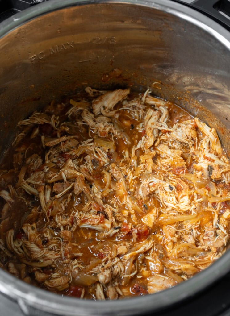 slow cooked shredded chicken in a pot