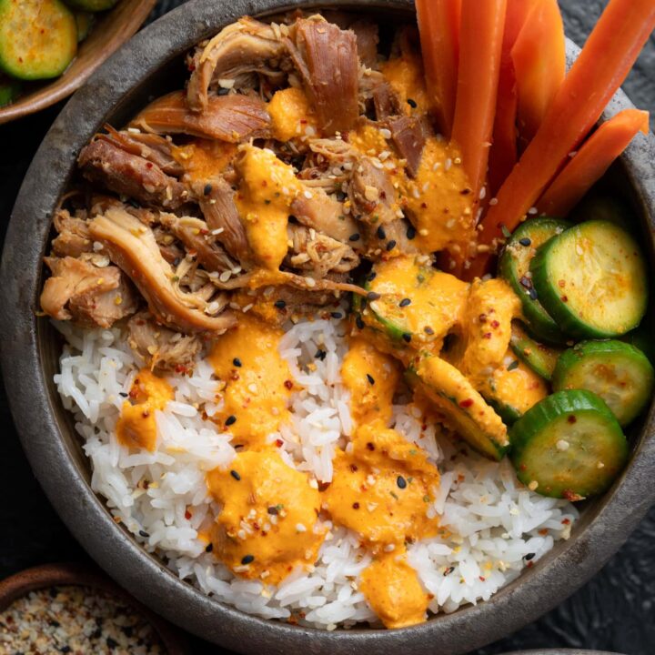 slow cooked Korean chicken bowls with pickled carrots and cucumbers, jasmine rice, and creamy blended kimchi sauce