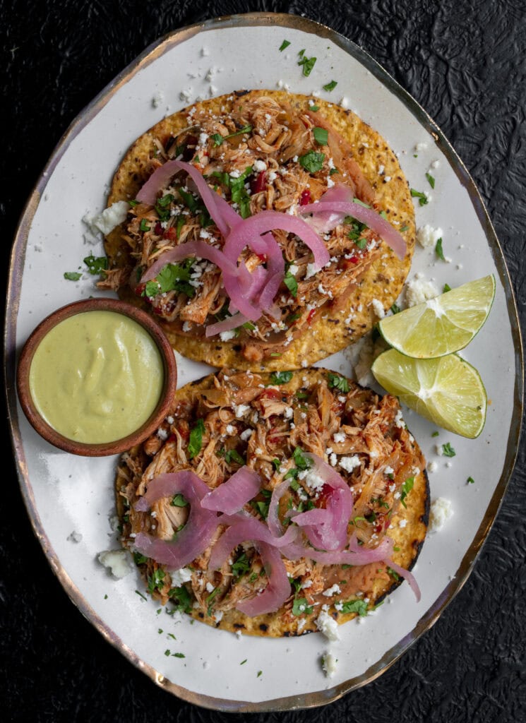 two slow cooker chicken tostadas with pickled onions