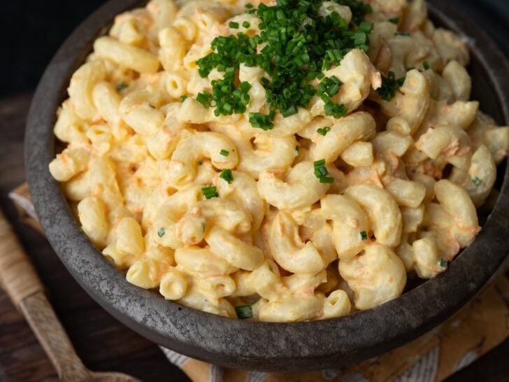 a bowl of high protein macaroni salad garnished with chives