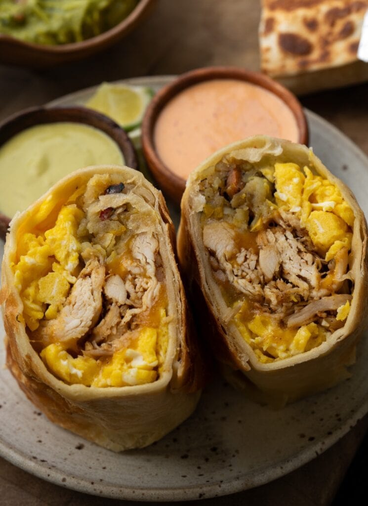 shredded chicken breakfast burrito sliced in half