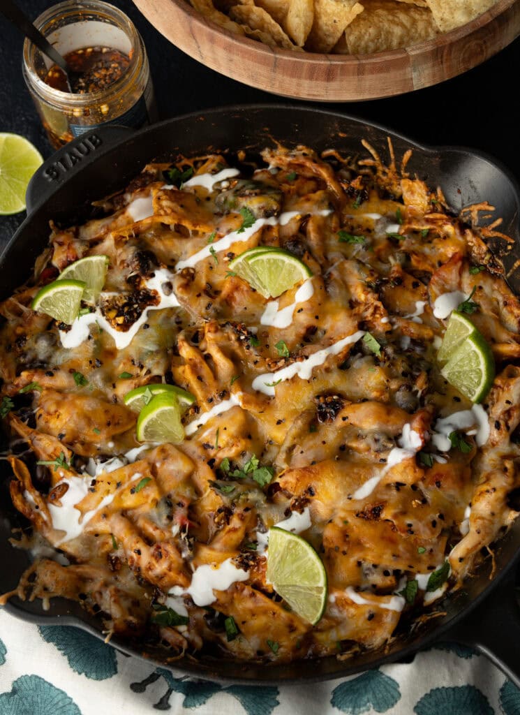 cast iron skillet casserole with tortilla chips and garnishes