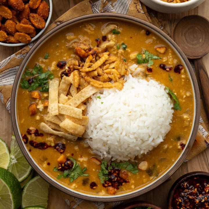 Thai yellow chicken curry in a bowl with rice and garnishes