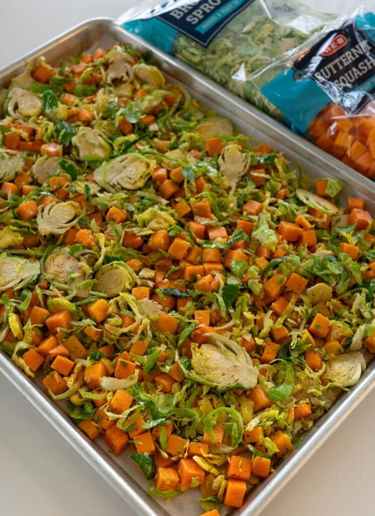 H-E-B diced butternut squash and shaved brussels sprouts on a half sheet pan 