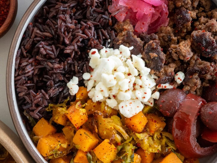 ground beef bowls with roasted butternut squash and shaved brussels sprouts, forbidden rice, goat cheese, pickled beets and onions