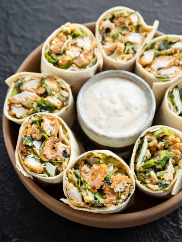 crispy chicken caesar wraps sliced in half and served with caesar dressing