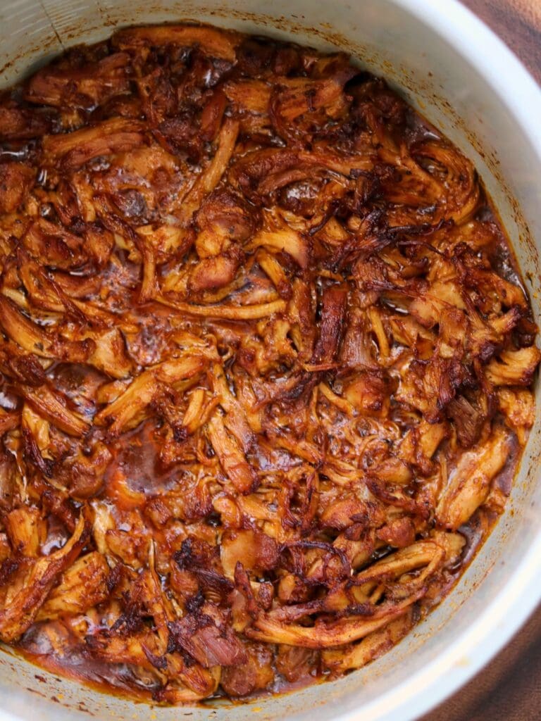 shredded bbq chicken thighs in a pressure cooker pot