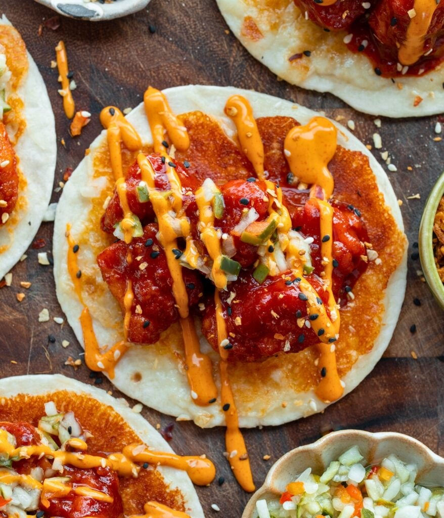 chicken nuggets with Korean bbq sauce on cheese crusted tortillas with pickle de gallo and gochujang mayo drizzle