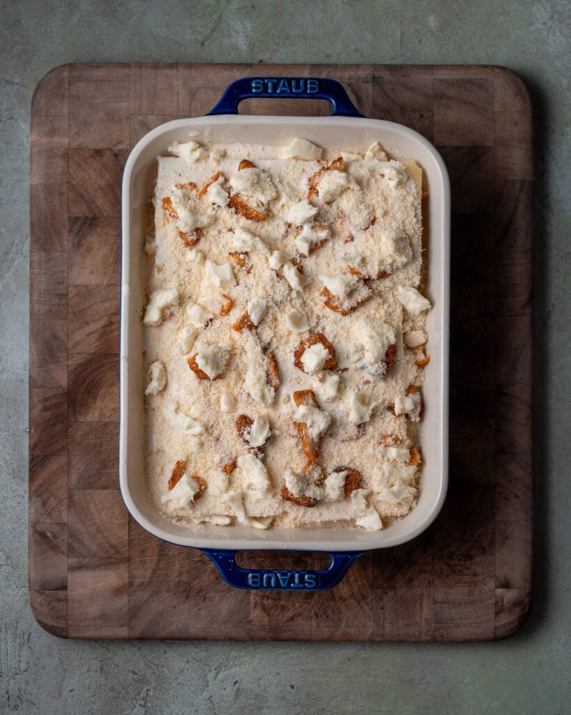 assembled chicken alfredo lasagna in a baking dish before covering and baking in a 425ºF oven