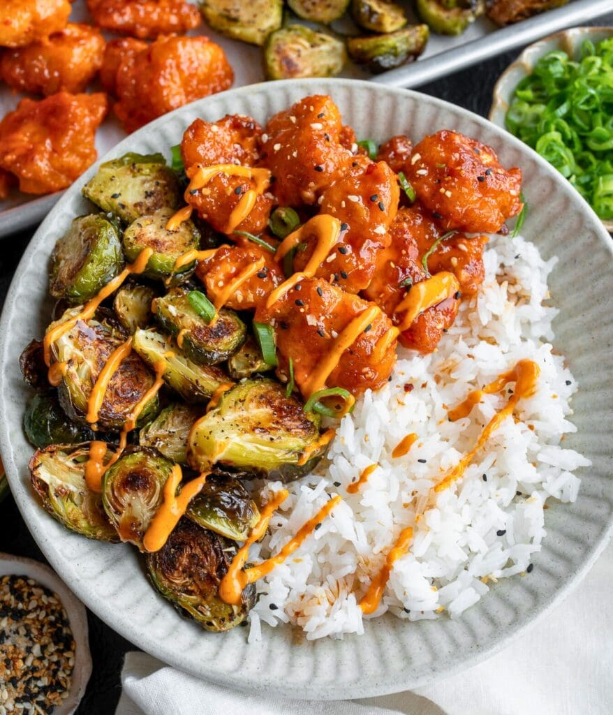 baked chicken nuggets and brussels sprouts with bang bang sauce and jasmine rice