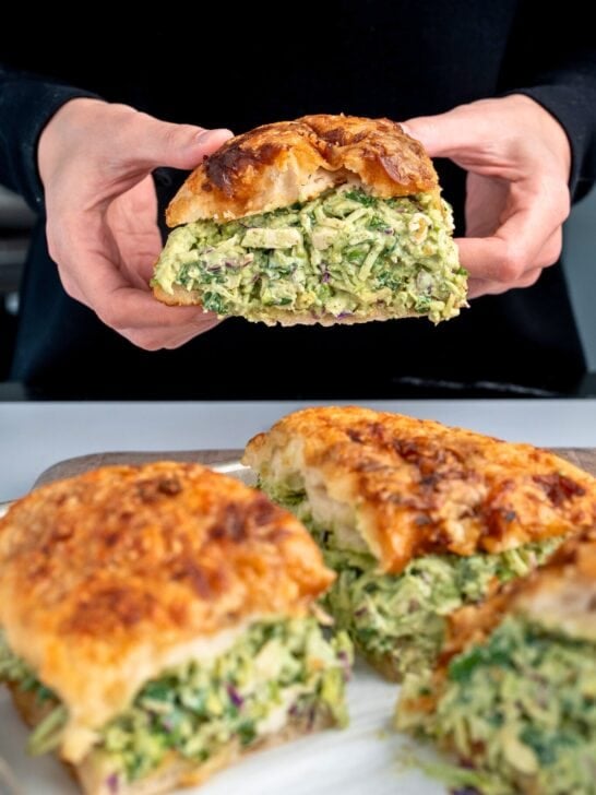 holding a pesto chicken salad sandwich on Trader Joe's french onion focaccia