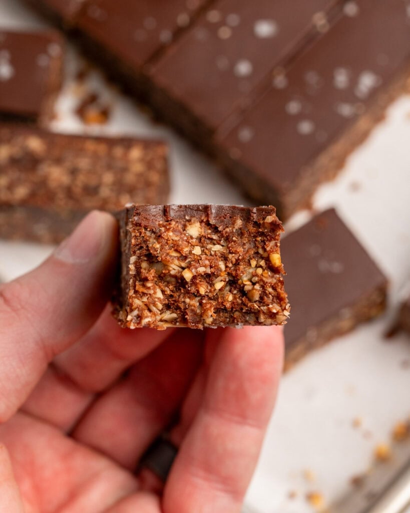 holding a chocolate granola bar