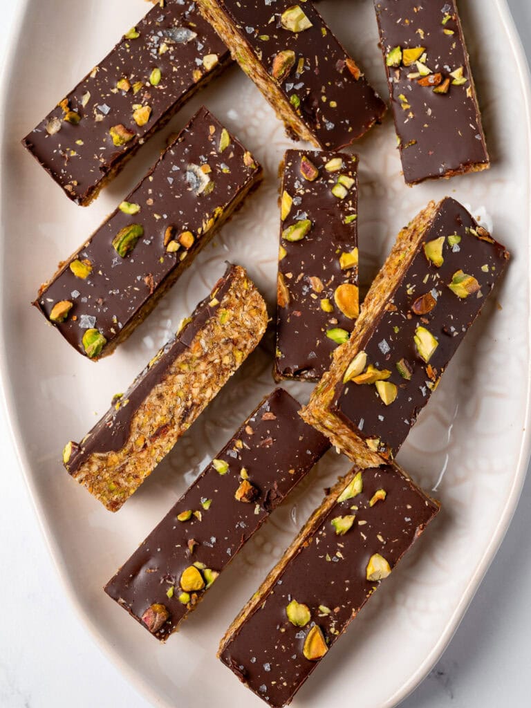 sliced chocolate pistachio granola bars on a plate