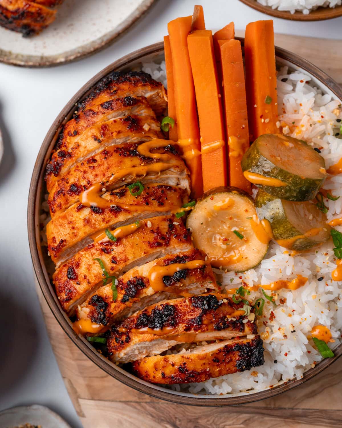 Air fryer gochujang halal chicken thighs with deep red sticky Korean glaze over rice with pickled cucumber for easy 18 minute weeknight dinner