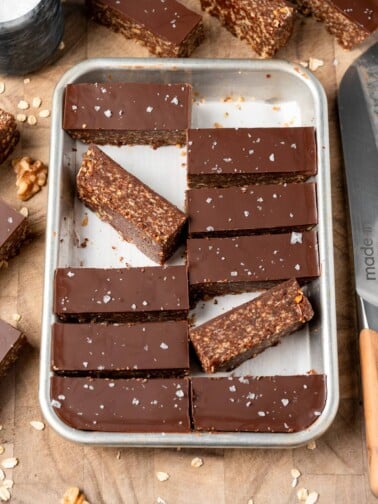 sliced dark chocolate granola bars on a sheet pan