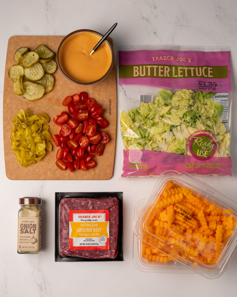 Trader Joe's butternut squash zig zags, butter lettuce, onion salt, extra lean ground beef, halved cherry tomatoes, pickles, pepperoncini, and burger sauce